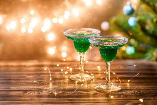 Christmas photo of two wine glasses with green cocktail