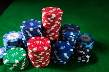 Casino poker chips on green table surface. gambling, fortune