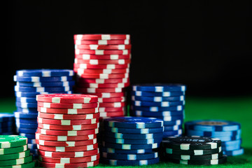 Casino poker chips on green table surface. gambling, fortune