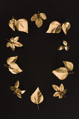 top view of various golden leaves arrangement isolated on black