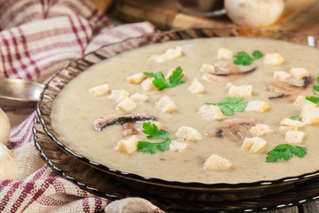 Mushroom cream soup with croutons and spices
