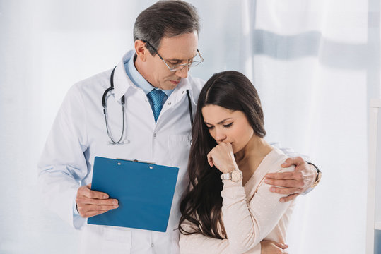 Male Doctor Hugging Upset Female Patient