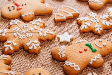 Christmas gingerbread cookies homemade and New Year decor on table with burlap tablecloth. Merry Christmas postcard.