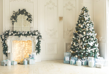 Christmas living room with a Christmas tree, fireplace, gifts and a large window. Beautiful New...