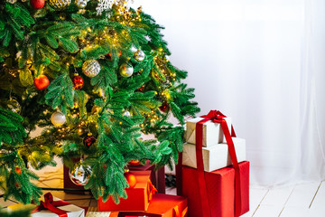 Christmas tree with gifts in Christmas living room. Beautiful New Year decorated classic home interior. Winter background