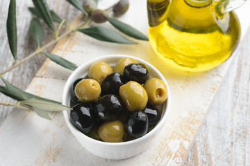 Olives with olive branch and olive oil, view from above