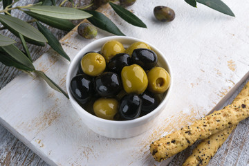 Olives with olive branch and olive oil, view from above