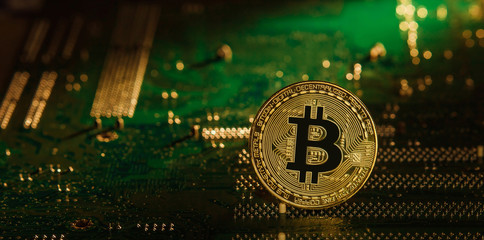 Gold silver Bitcoin on the chip. on a Green background. Crypt Of Safety. Virtual money. Mining. Security.