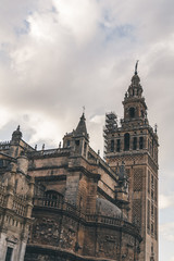 Fototapeta na wymiar old gothic Seville Cathedral under cloudy sky, spain