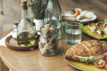 close-up view of sugar and sandwich on table for breakfast