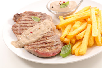 grilled steak with pepper sauce and french fries
