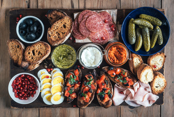 Bruschettas with ingredients for preparing served on the table,high angle