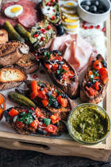 Bruschettas with ingredients for preparing served,selective focus