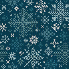Seamless knitted pattern with white and turquoise snowflakes