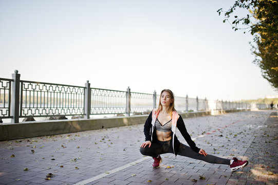 Young girl has the training and doing exercise outdoors. Sport, fitness, street workout concept.