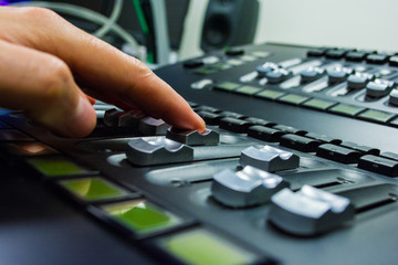 Fototapeta premium hand on a light, mixing desk fader in blur television gallery