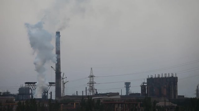 Air pollution industrial factory. Pipes with smoke in the sky