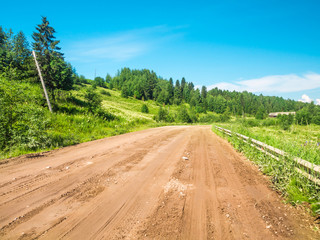 Fototapeta na wymiar Countryside Dirt Road Going Uphill In Summer