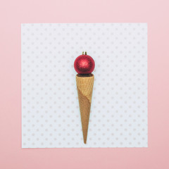 Christmas decoration bauble in ice cream cone. New Year minimal concept.