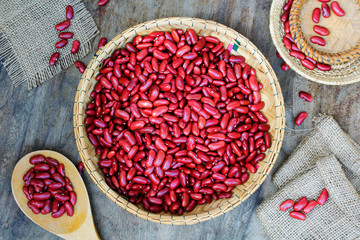 Red kidney bean on rattan cup on wooden background