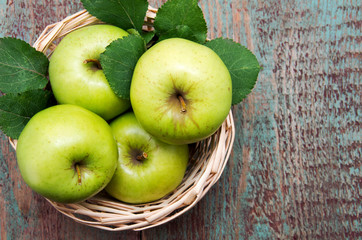 green apple on a wooden table.
