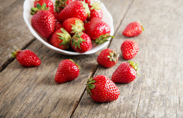 Ripe red strawberries on wooden table