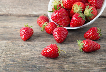 Ripe red strawberries on wooden table