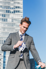 angry businessman rips documents in pieces