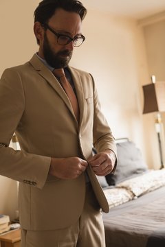 Man wearing his blazer in bedroom