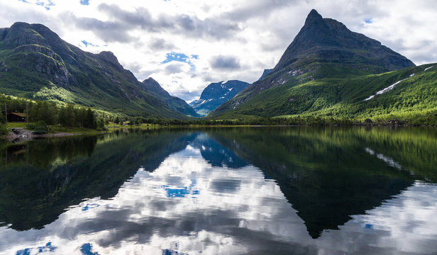 Innerdalen - Norways most beautiful mountain valley. Shot close over the water looking in on the valley.
