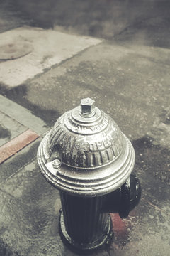 Retro stylized picture of a fire hydrant in New York City, selective focus.
