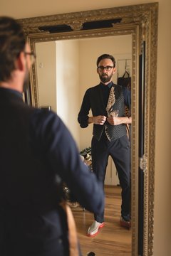 Man wearing waist coat at home