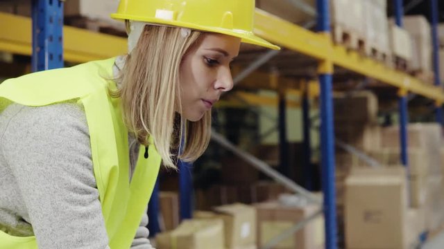 Woman warehouse worker with barcode scanner.