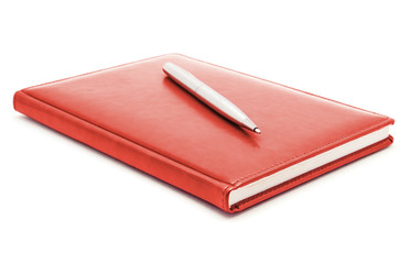 Red diary and pen on a white background