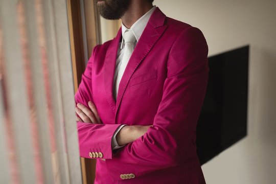 Man in suited looking through window