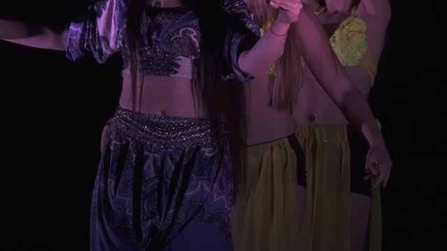 Sexy, young woman belly dancer arabian in exotic dress dancing exotic dance.