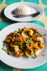 Urap Urap with an extra rice, vertical with rice in background.