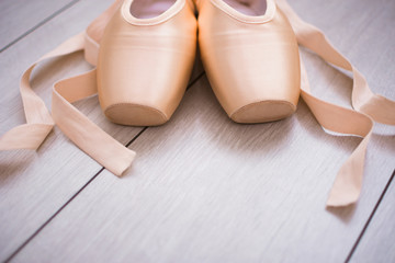 Ballet point shoes on wooden background