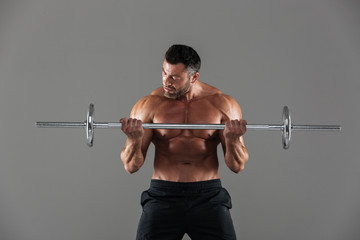 Fototapeta na wymiar Portrait of a muscular motivated shirtless male bodybuilder