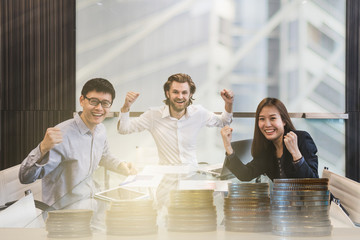 Multi ethnic Business team celebrate financial success double exposure with modern building, trade graph and coins.