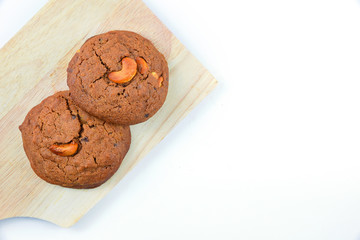 Cashews cookie on wooden boards and white background.