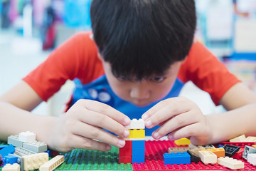Boy play colorful toy block puzzle set for brain practice