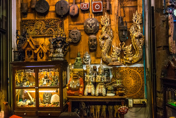 masks and ancient ornaments, antiques in old shop in thailand. asia