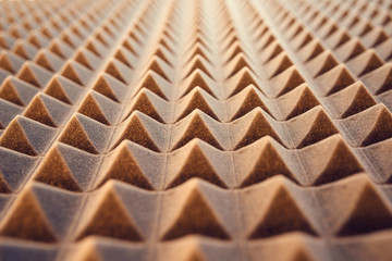 Closeup pattern of acoustic foam panel background, toned image