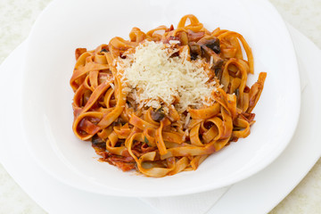 Penne pesto.Penne, tomato sauce and vegetables on white background