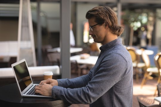 Man using laptop in chocolate bar