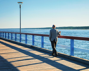 Man in Sea Bridge looking Baltic sea in Palanga resort