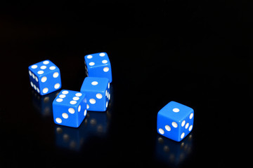 Five blue hexa dice on a black background
