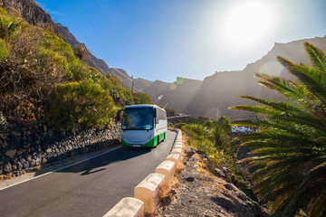 Beautiful landscape with a bus on the road towards Masca village in Tenerife, Canaray island of Spain - obrazy, fototapety, plakaty
