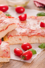 Italian pizza with cheese, tomatoes and fresh basil. 
